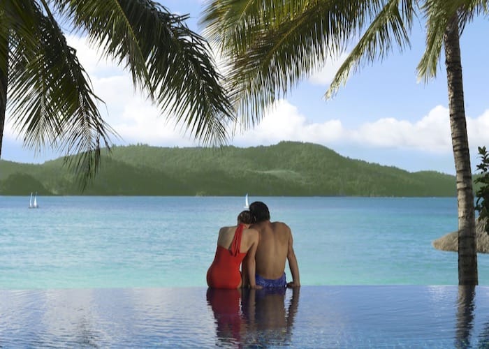 Couple on the edge of infinity pool at Beach Club in the Whitsundays