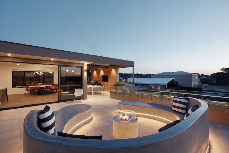 Carmel at Sorrento has a minimalist industrial chic style seating around a fire pit on the rooftop.