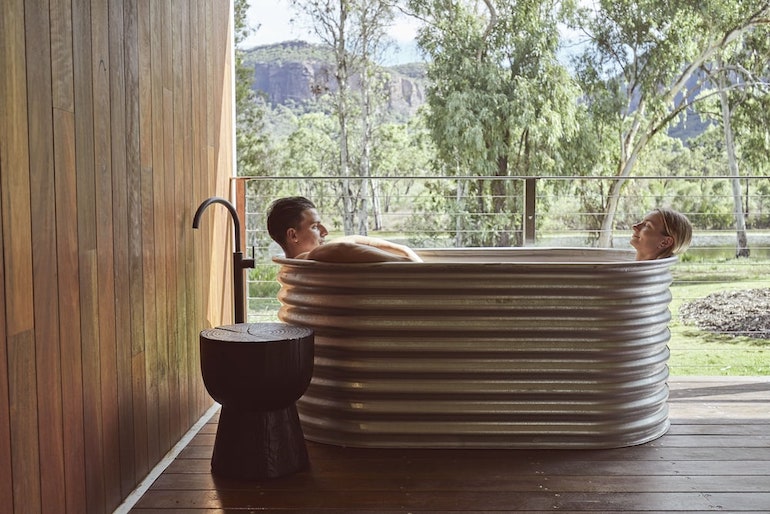 Couple relaxing in a tub at Mt Mulligan Lodge