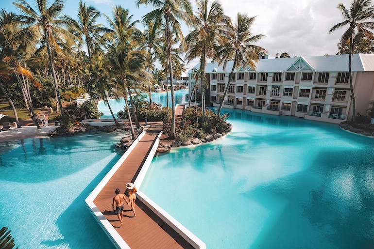 Couple walking in between the lagoon pools of Sheraton Grand Mirage Port Douglas