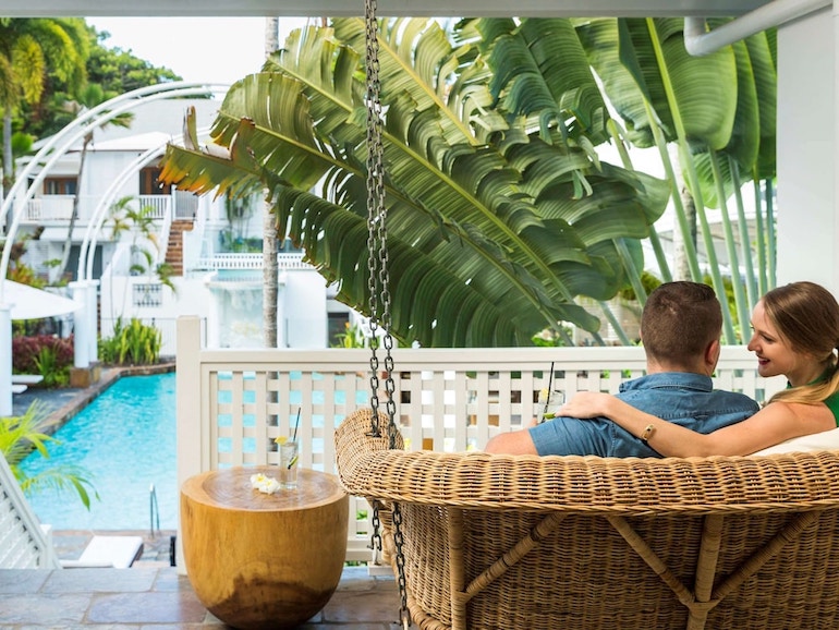 Couple on a swing for two at The Reef House Palm Cove