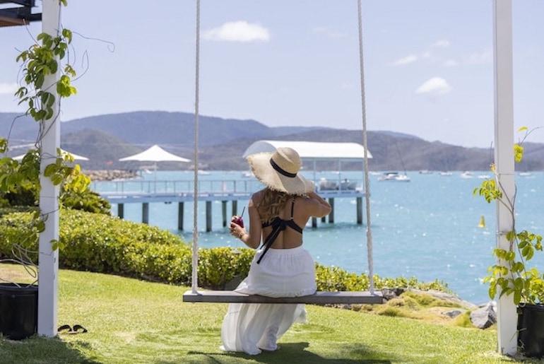 Woman on a swing at Coral Sea Marina Resort