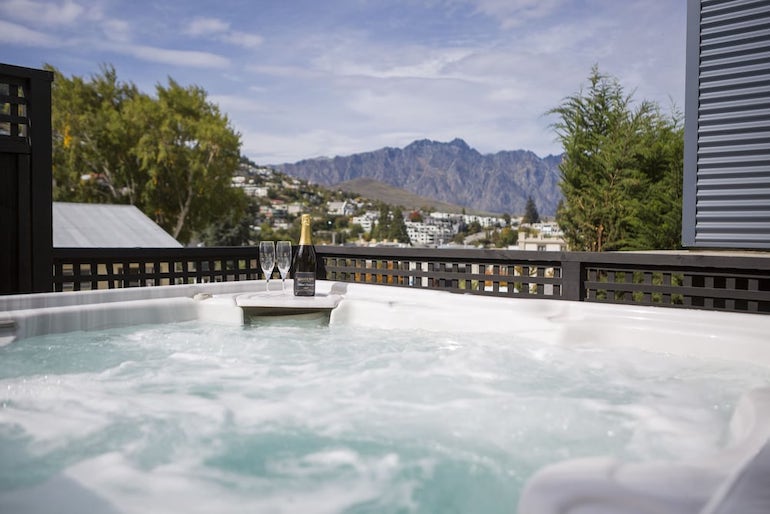 Champagne with views of the mountain while in the outdoor spa tub at the Dairy Private Hotel.