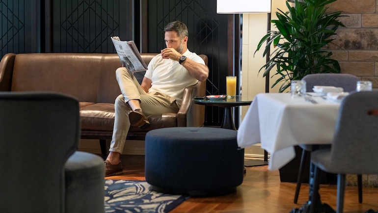 Guest having coffee at the InterContinental Sanctuary Cove Resort