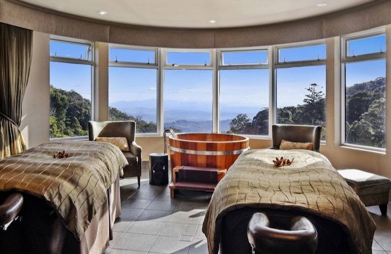 Massage tables and wooden bath tub overlooking the rainforest at O'Reilly's Rainforest Retreat