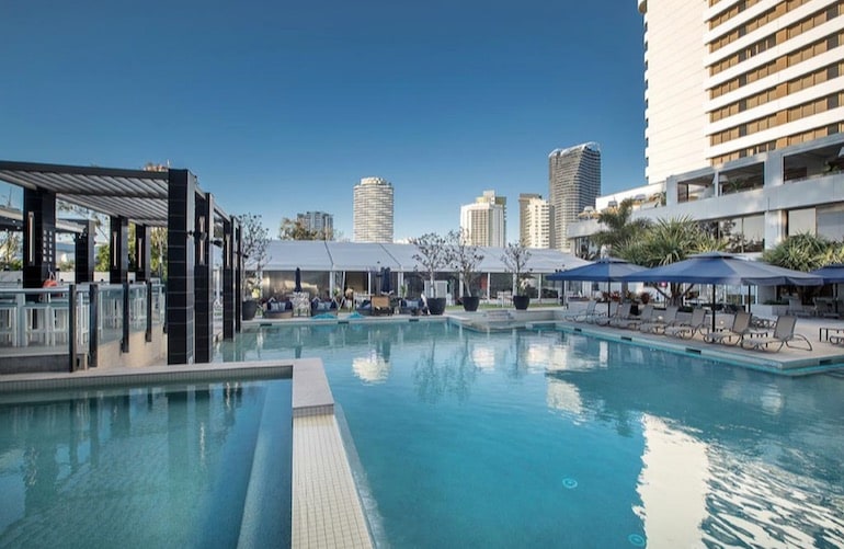 Shaded poolside loungers and the outdoor pool at The Star Grand at The Star Gold Coast