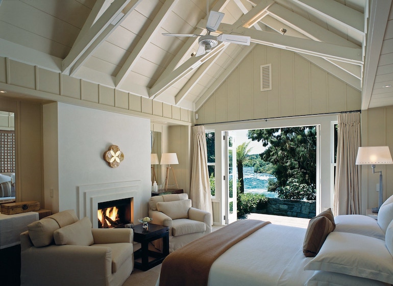 Huka Lodge bedroom with fireplace and seating area