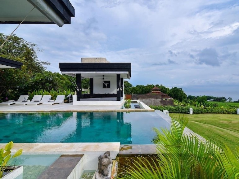 Infinity pool, loungers, and gazebo at Villa Pondok Wahyu