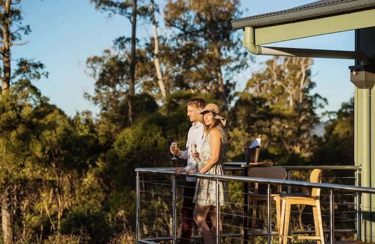 Couple out on their private Balcony at Cradle Mountain Lodge