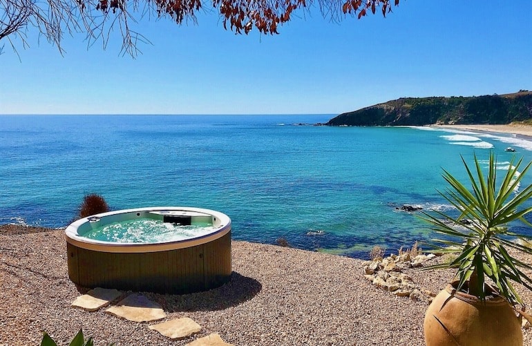 Outdoor spa tub with ocean views at Lifetime Private Retreats